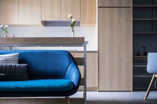 To open up the space visually, JAAK incorporated storage into a single wall that’s positioned next to an open kitchen. This frees up the other three walls and makes the apartment look much bigger. 