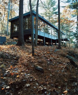 9 Eco-Friendly Homes With Smart, Sustainable Features - Photo 2 of 9 - This cabin retreat in the woods of Ontario, Canada, has windows that were recycled from a Toronto skyscraper. It's outfitted with self-powered Ecofans, a 65-gallon pressurized tank with a pump that doesn’t require constant power to operate, an on-demand propane water heater and refrigerator, and a 19,000 BTU commercial-grade Wolf stove that's been converted from natural gas to propane.