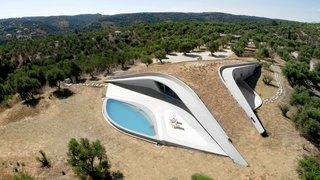 8 Subterranean Homes That Are Out of This World - Photo 5 of 8 - Embedded into the top of a hill, Villa Ypsilon in the Greek seaside village of Messenia has a Y-shaped, earth-covered roof promenade that looks as if it's an extension of the terrain. 