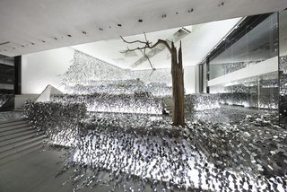 Japanese designer Nendo cut mirrored, stainless-steel sheets into 2,000 rhombus-shaped sections, which he then strung together into an "ivy of mirrors." The installation of reflective shards is spread across a layered stone garden within the Sogetsu School of Ikebana in Tokyo.