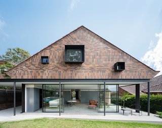 When renovating this 1930s Arts and Crafts-style bungalow in Sydney, TRIBE Studio Architects used vertically and horizontally stacked bricks in three different shades to create an interesting, modern facade at the garden-facing rear of the property. 