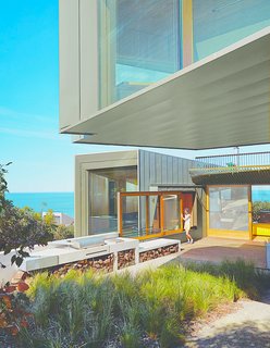 Sited along the Great Ocean Road, this contemporary home in the village of Fairhaven was designed by architect John Wardle. Surrounded by Eucalyptus trees and facing the sea, the house’s kitchen leads to an outdoor deck and BBQ area that’s perfect for post-surf dinners.