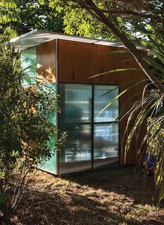 10 Prefabricated or Modular Structures That Use Plywood in Creative Ways - Photo 6 of 11 - This case study-like home in New Zealand has a frame of timber that's clad in alternating modules of stained plywood and colorful, semitransparent polycarbonate.