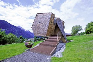 Designed by architects Peter and Lukas Jungmann, this holiday cabin near an old farmhouse in the East Tyrolean village of Nussdorf, Austria, is covered in rustic Austrian-style shingles. Its sharp angles and asymmetrical shape gives it a distinctly futuristic, UFO-like appearance. 