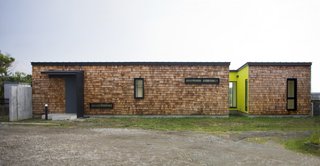 Designed by Tokyo architecture practice Sohei Nakanishi Design, this seaside getaway has a facade that combines rectangular red cedar shingles with rounded-edged "fish-scale" shingles for an unusual visual and textural composition.