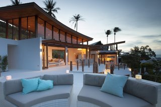 Designed with soft, flowing lines and organic curves, Villa Kya has a free-form pool and a living room with vaulted ceilings and concertina doors that open to a large dinning terrace.