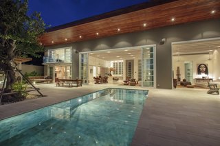 This contemporary villa has three en suite bedrooms, a sandstone sun terrace, and an infinity-edge pool with an outdoor mirror feature that captures reflections of the modern Asian interiors.