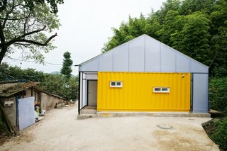 Discover 5 Public Buildings in South Korea Made Out of Shipping Containers - Photo 3 of 10 - With sponsorship from the Korea Child Fund, Seoul practice JYA-Architects designed this low-cost home in the small county of Jangheung in the southeastern province of South Korea. It was created to help improve the quality of life of a low-income family of seven. Using just three shipping containers and light-gauge, translucent framing, this home is a great example of how sustainable design can be used to address a tight budget.