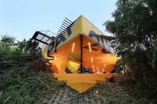 Discover 5 Public Buildings in South Korea Made Out of Shipping Containers - Photo 7 of 10 - Eight shipping containers that are shifted and cut along a 45-degree angle are combined in a fishbone pattern to create a sculptural, arrow-shaped volume that’s raised almost 10 feet above ground. Designed by New York-based firm LOT-EK, the building serves as an art school near the Hakwoon park pedestrian walkway in Anyang, as well as a focal point and landmark structure for the area.