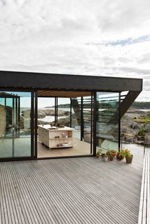 A Norwegian Summer Cabin Embraces the Rocky Terrain - Photo 8 of 10 -