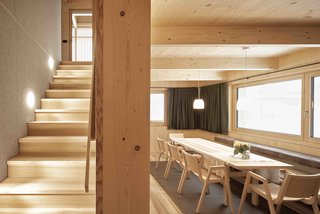 This holiday house in Islen, in the Austrian municipality of Mellau, is composed of eight prefabricated, modular boxes that arrived on-site fully furnished—even the curtains were installed. The only element that was completed on site was the sloping roof, which was created with prefab panels. Made using sustainable materials like native spruce and ash wood, and a rice husk composite for the surfaces of the wet areas, the entire building was erected in a single day.