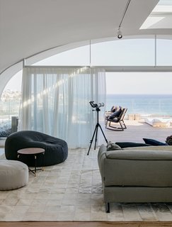 This two-story, three-bedroom penthouse located at the top of the multi-use development of Pacific Bondi Beach was designed to evoke the "relaxed sophistication" of its chic Australian beach locale.
