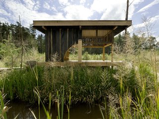 Named after its charred-larch cladding, this tearoom designed by Czech studio A1 Architects sits next to a lake in a woodland area near the city of Česká Lípa in the Czech Republic. Its sliding doors can be opened for enhanced connectivity with the surrounding nature, or closed to create a more secluded oasis. At the center of the space is a hearth with a teapot suspended from a sisial rope-domed ceiling above it.
