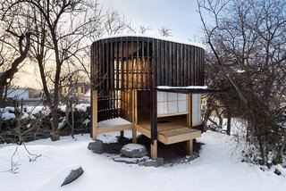 Another project by A1 Architects, this teahouse rests on a circular platform enclosed by a translucent dome. Within, the dome is covered in laminated paper, which allows light to shine through, imbuing the interiors with an ethereal glow.