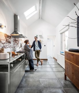 Passionate about recycling, Belgium designer couple Michaël Verheyden and Saartje Vereecke reused a veined marble top from a massive table from Vereecke’s parents’ house as the backsplash for their kitchen.