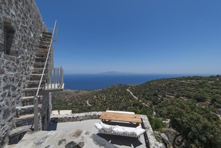 Discover 8 of the Best Mediterranean Homes - Photo 3 of 11 - On the island of Nisyros in the Aegean Sea, Villa Nemésis brings modern design to a 14th-century castle. The villa’s expansive sun terrace, rooftop deck, and alfresco dining area are perfect for enjoying the Mediterranean sunshine and cool Aegean breezes.