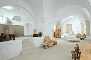 The arched walls and thresholds of this old oil mill residence in Salento, Puglia, serves as a dramatic backdrop for Ludovica+Roberto Palomba to showcase their custom creations and iconic Italian furnishings.