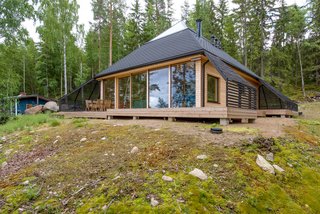 Architect Paolo Caravello of Helsinki-based practice Void created this prism-shaped house near a lake in Sysmä, Finland, with a glass-topped pyramidal roof that transformed the top level of the house into a fully glazed observatory where its owners can look out to stunning views of nature.