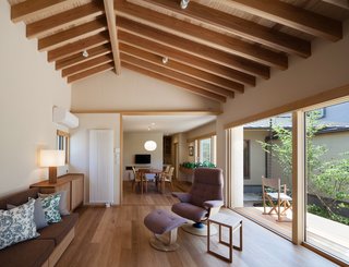 The living room features a sofa by Room & Board club chairs by Dartbrook Rustic Goods.