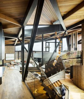 The chandelier in the stairwell was custom-designed by Esque Studio.