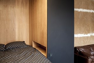 The modern space celebrates the rough-hewn character of the old apartment.