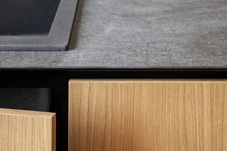 A kitchen counter with built-in cabinetry
