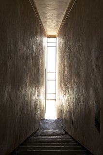 A narrow glass window cuts through the interiors from floor to ceiling.