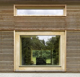 Picture windows frame views on both ends of the kitchen of the kitchen counter.