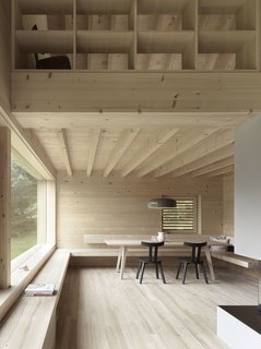 A wooden bench wraps along a dining corner and extends towards the fireplace, where it serves as a bookshelf and fireside bench.