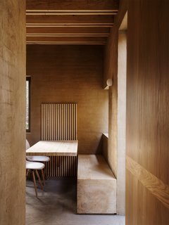 A dining area with a built-in bench and table