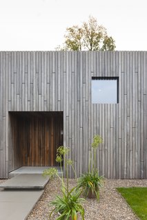 Like the windows, the front door is also a square to extend the motif.