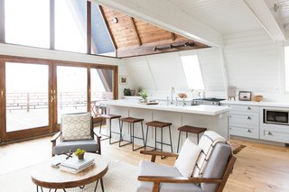 These 30 White Kitchens Are Anything But Ordinary - Photo 29 of 30 - The orientation of the kitchen was changed to allow sunlight from the slanting windows to better illuminate the cooking station. 