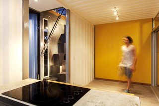 The kitchen and a staircase that leads up to the bedroom