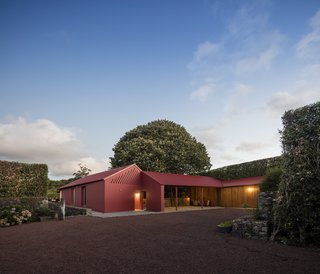 A Bright Red Island Residence Embraces a Linden Tree - Photo 2 of 13 -