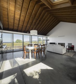 A Bright Red Island Residence Embraces a Linden Tree - Photo 7 of 13 - The western windows of the living room look out to the coast.