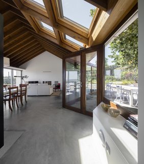 A Bright Red Island Residence Embraces a Linden Tree - Photo 9 of 13 - Four generous skylights flood the interiors with light.