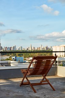 This Slender Concrete Home in Brazil Feels Like an Urban Jungle - Photo 12 of 13 - The house sits at an elevated position, offering great views of the city.