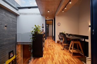 This Slender Concrete Home in Brazil Feels Like an Urban Jungle - Photo 8 of 13 - The study room and library are tucked away on the second level.