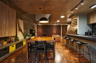 This Slender Concrete Home in Brazil Feels Like an Urban Jungle - Photo 6 of 13 - The dining and kitchen on the ground floor.
