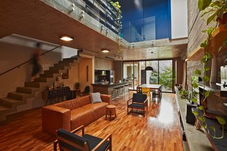 This Slender Concrete Home in Brazil Feels Like an Urban Jungle - Photo 1 of 13 - Stairs lead up to the upper level.