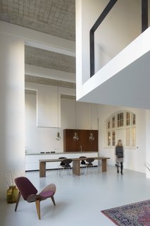 A 20th-Century Dutch Schoolhouse Now Holds a Series of Airy Lofts - Photo 6 of 13 - The kitchen and dining area
