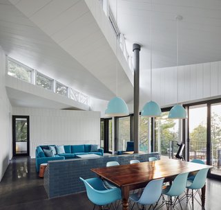 The living room has a cheerful, blue-and-white color scheme.