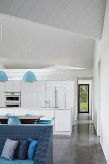 Glossy, dark-dyed, glossy concrete floors extend throughout the space.