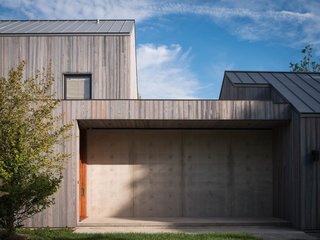 This house on the "Lanes" was designed with concrete foundational walls, charred siding, and VMZinc zinc roof.