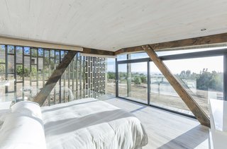 A bedroom looks out to stunning coastal views.