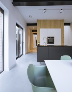 A 19th-Century Dutch Workshop Is Now a Stunning, Spacious Loft - Photo 3 of 13 - A sleek, streamlined open-concept kitchen.