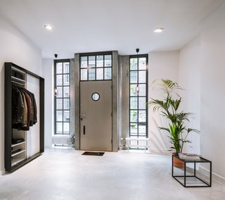 A 19th-Century Dutch Workshop Is Now a Stunning, Spacious Loft - Photo 2 of 13 - Glass windows in the entrance foyer bring in lots of natural light from the outdoors.
