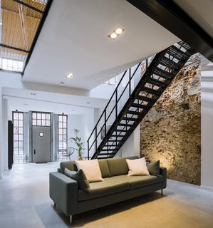 A 19th-Century Dutch Workshop Is Now a Stunning, Spacious Loft - Photo 4 of 13 - The wooden floor structure of the upper level and existing steel beams were retained.