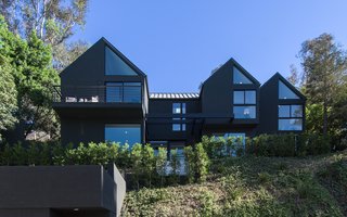 Red Hot Chili Peppers Frontman Anthony Kiedis' Former L.A. Abode Asks $3.2M - Photo 1 of 13 - The house has a standing-seam metal roof and is finished with black-tinted stucco.