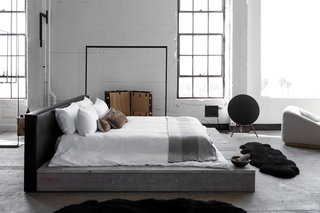 The bedroom houses bedding by Society Linen, a striped throw by Tenfold from The Line, and vintage embroidered textile pillows.